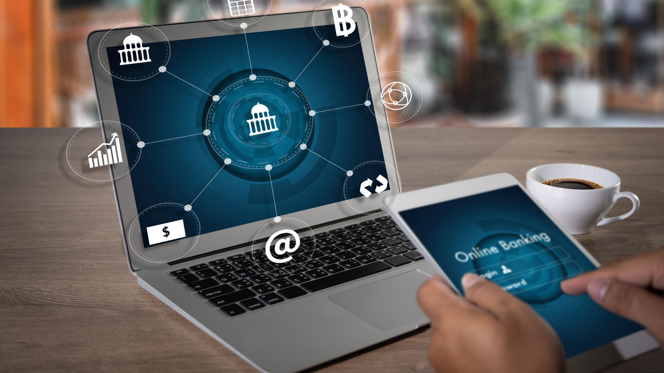 Person using mobile device and computer to perform digital banking